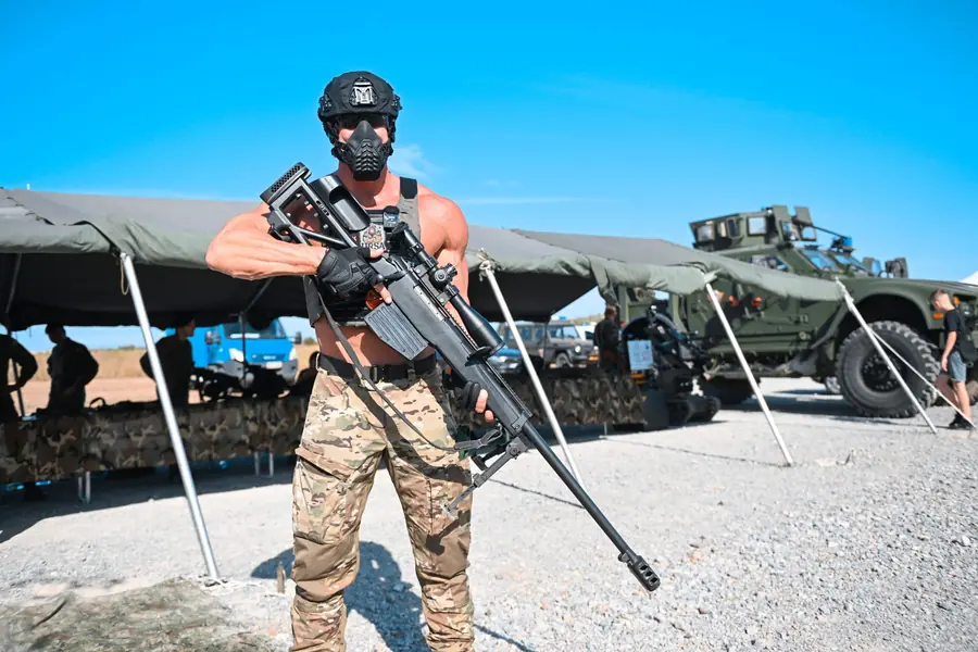 Operator presenting a long-range anti-materiel rifle at the outdoor demonstration area