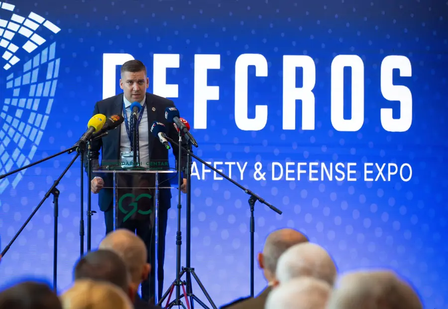 Speaker addressing the press at the DEFCROS Public Safety & Defense Expo podium