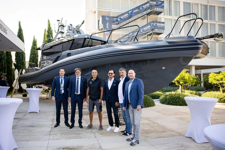 Patrol boat on display outside the convention centre, with its team