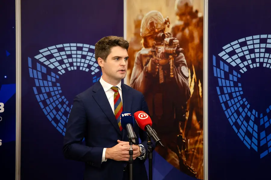 Television interview in front of the DEFCROS 3 media wall
